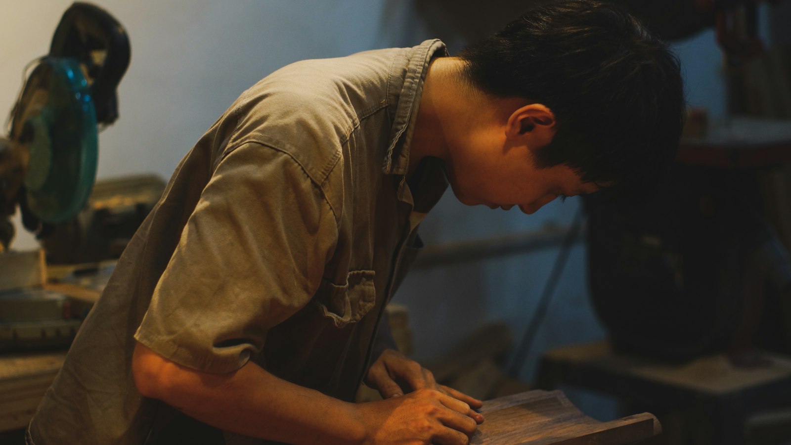 Craftsman working a piece of wood at his bench